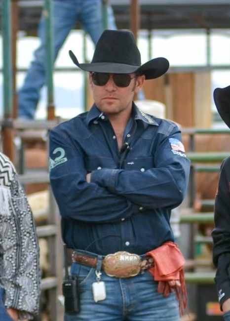 CJBaca Man in blue shirt, black cowboy hat and sunglasses standing with arms crossed
